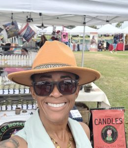 House of Mosaic Candles founder Toni Shaw at an outdoor community pop-up market in Los Angeles.