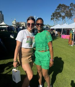 Customer shopping with Founder Toni Shaw at the House of Mosaic Candles booth during a local pop-up event.